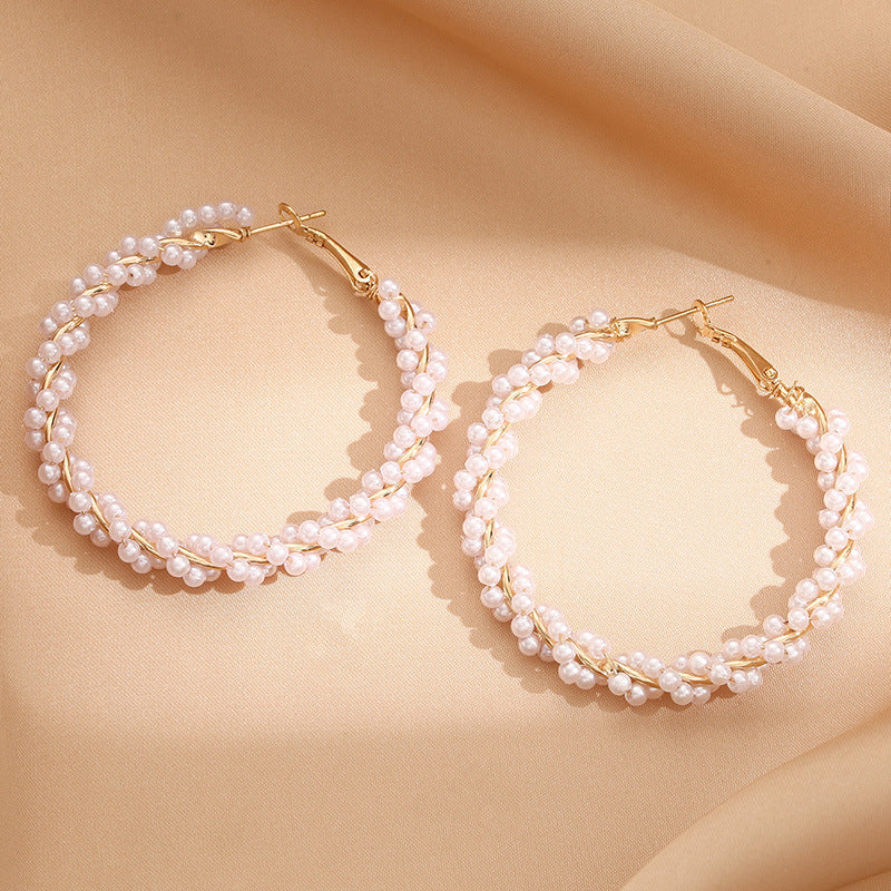 Ladies hoop earrings with luxurious pearl accents and elegant, twisted design Symbol Fashion