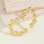 Women's bracelet with structured, golden beads Symbol Fashion