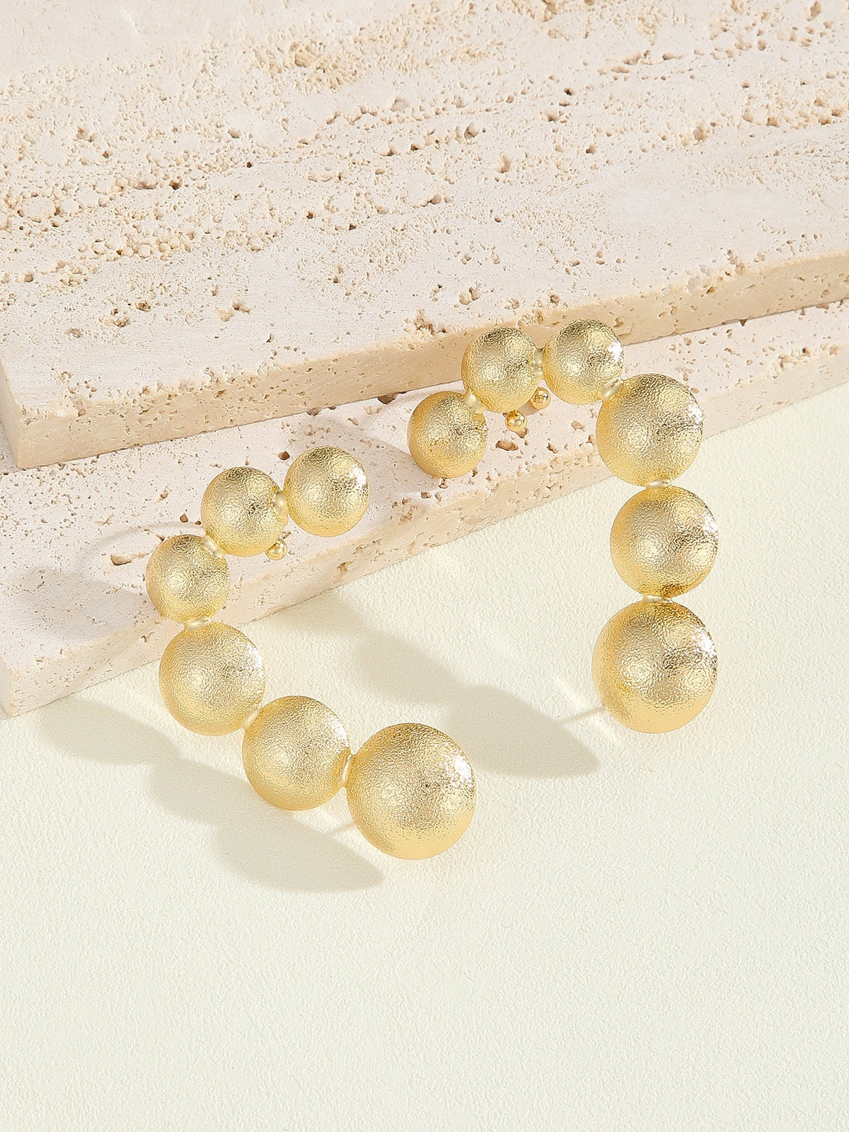 Women's bracelet with structured, golden beads Symbol Fashion