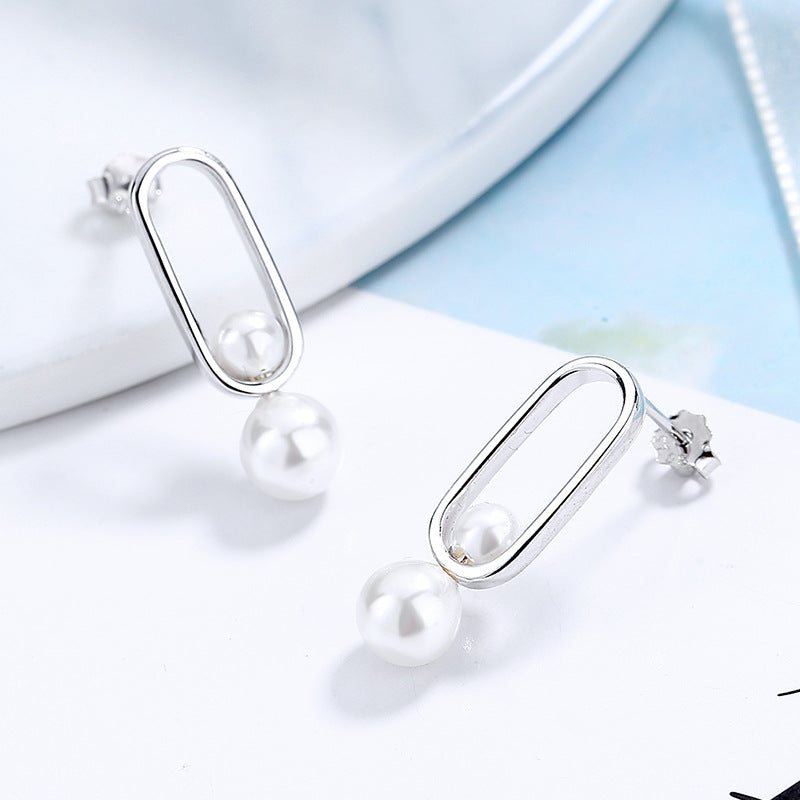 Women's stud earrings with modern oval design and elegant pearls Symbol Fashion