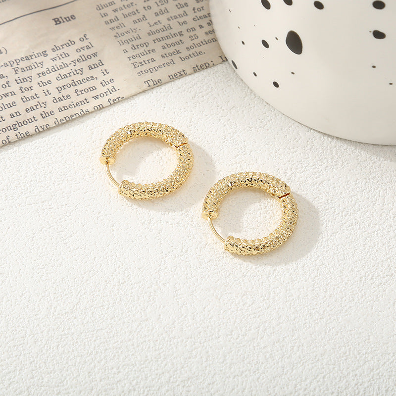 Women's hoop earrings with modern, textured design Symbol Fashion