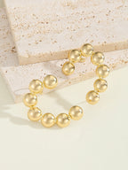 Women's bracelet with structured, golden beads Symbol Fashion