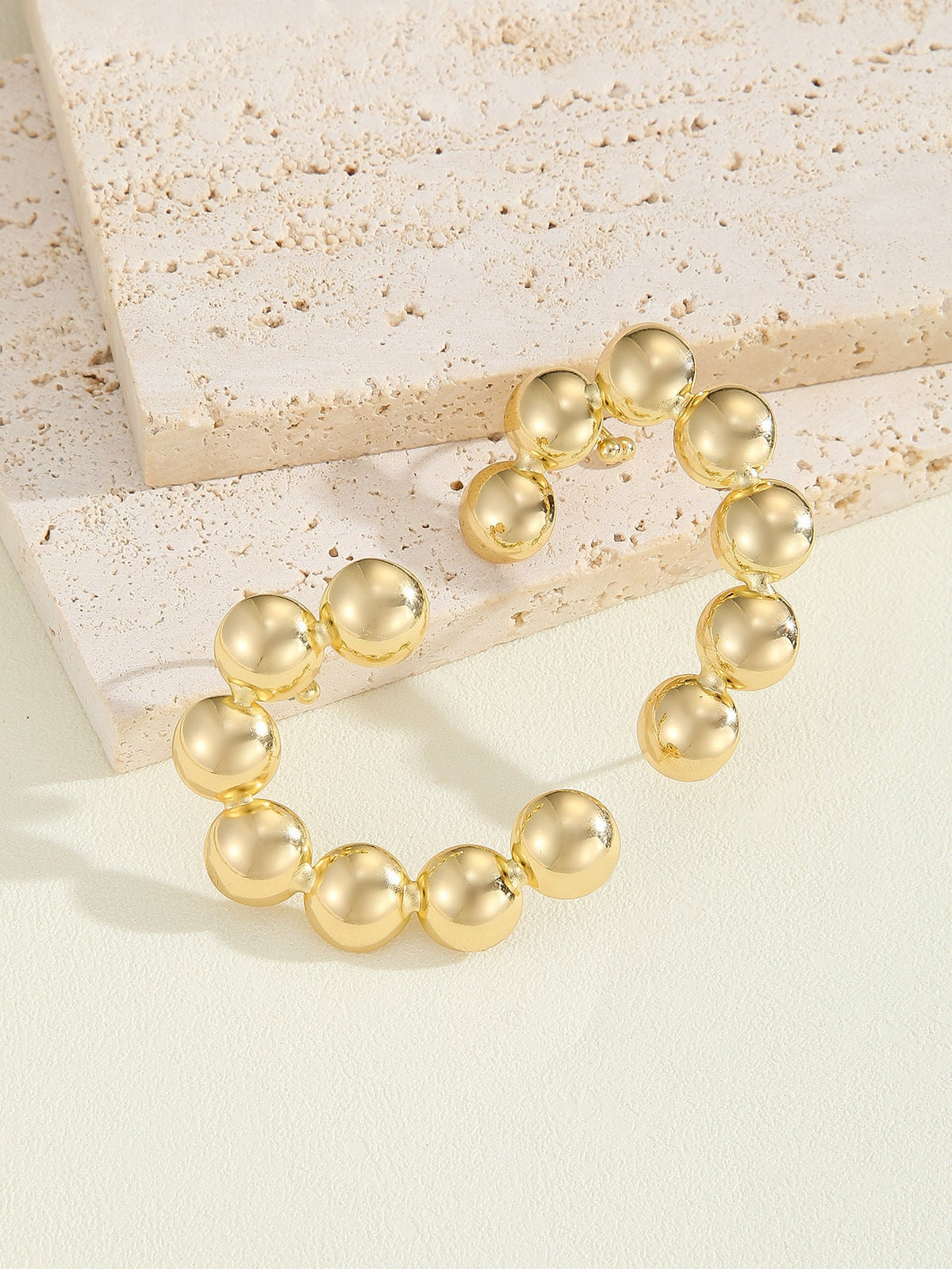 Women's bracelet with structured, golden beads Symbol Fashion