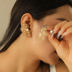 Women’s ear clips with elaborate flower design and pearl accent Symbol Fashion