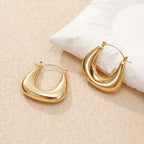 Ladies earrings in a modern, curved design Symbol Fashion