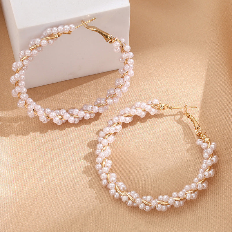Ladies hoop earrings with luxurious pearl accents and elegant, twisted design Symbol Fashion