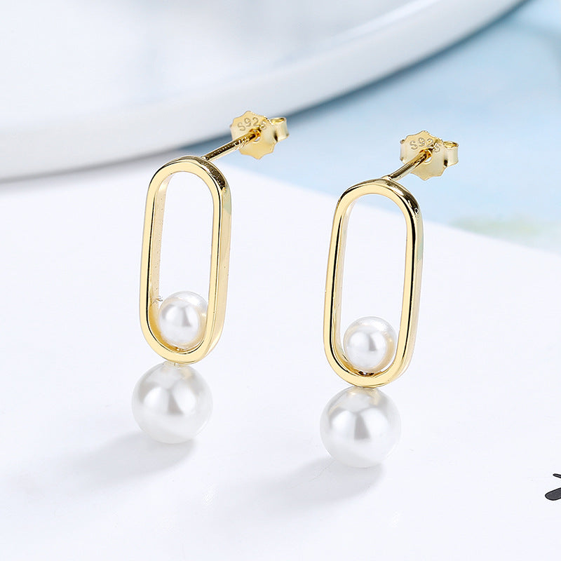 Women's stud earrings with modern oval design and elegant pearls Symbol Fashion