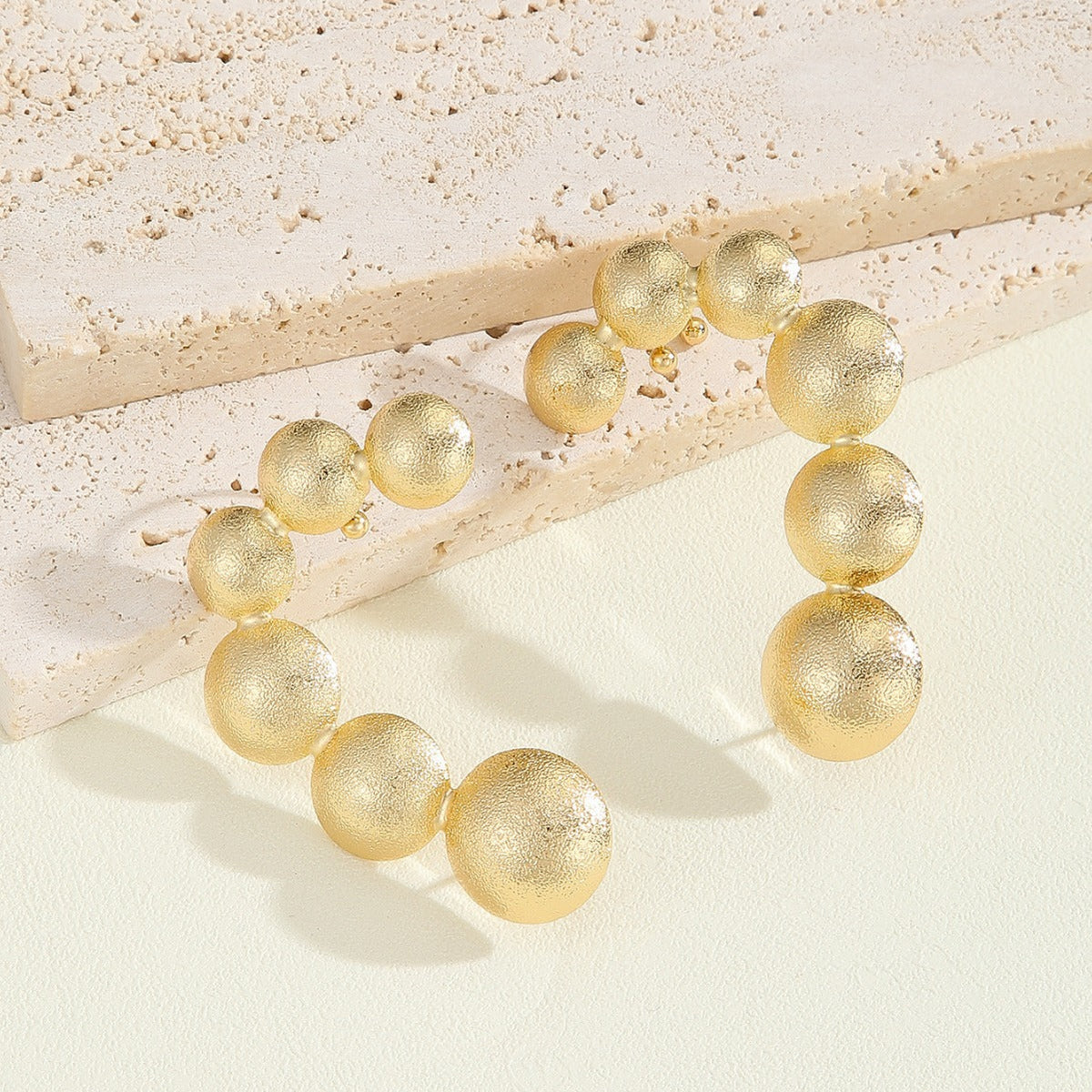 Women's bracelet with structured, golden beads Symbol Fashion