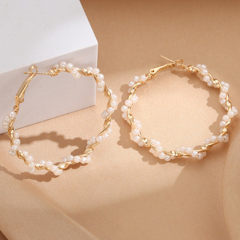 Ladies hoop earrings with luxurious pearl accents and elegant, twisted design Symbol Fashion