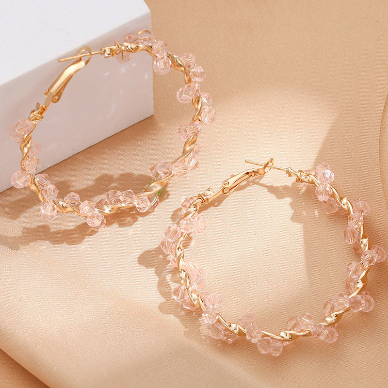 Ladies hoop earrings with luxurious pearl accents and elegant, twisted design Symbol Fashion